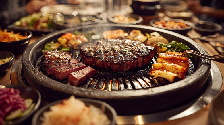 Meat and vegetables cooking on a Korean barbecue pan.