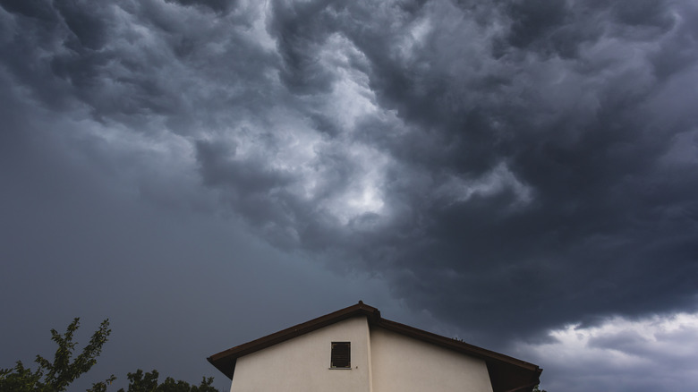 A storm gathering above the roof of a residence