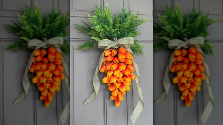 Carrot-shaped door wreath made from orange tulips.