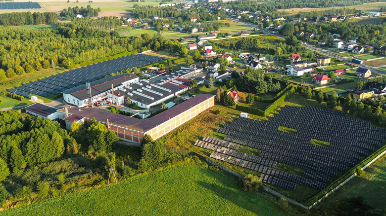 A large solar farm is shown next to a residential suburb.