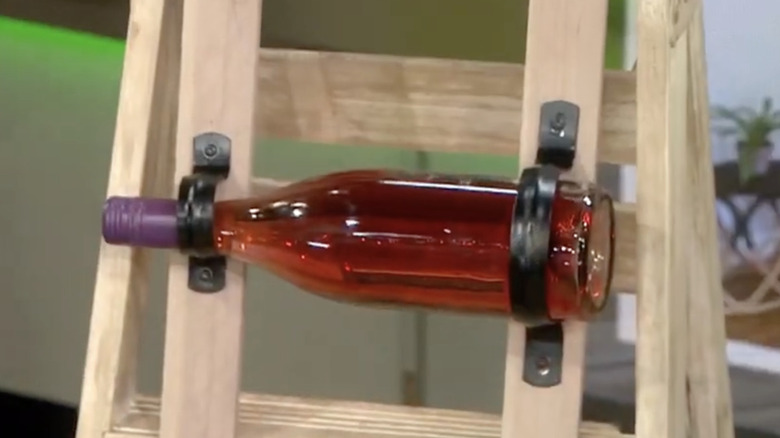 Red wine bottle on homemade wine storage rack