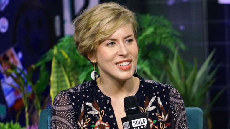 Erin Napier smiling on talk show holding microphone
