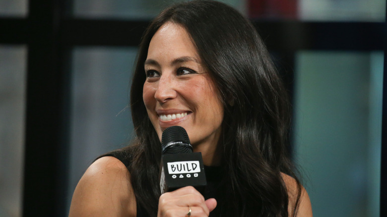 Joanna Gaines holding microphone smiling