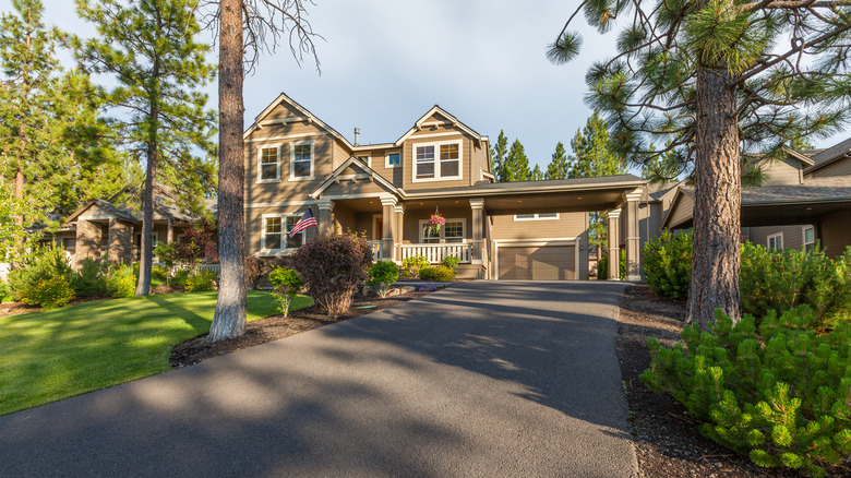 Beautiful modern luxury home with classy asphalt driveway and landscaping