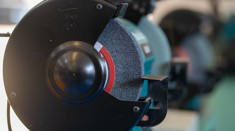 A close-up of a bench grinder's wheel