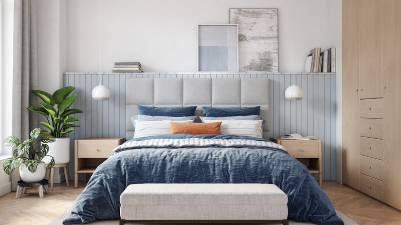 bedroom with accent wall shelf behind