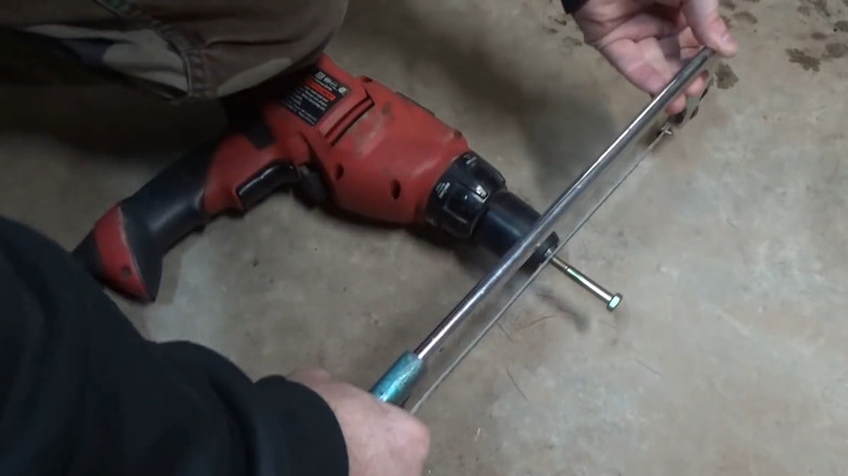 Cutting a bolt to size with a power drill and a hacksaw
