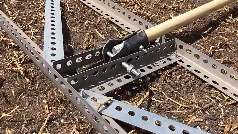 A DIY lawn leveling tool on dirt