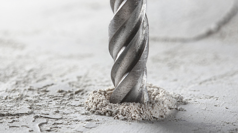A bit making a hole in concrete