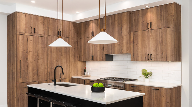 Kitchen with wood cabinets extended up to the ceiling