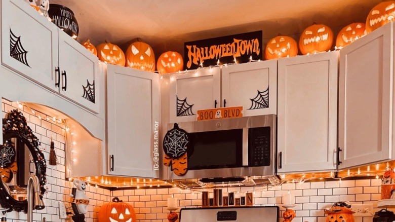 Kitchen decorated for Halloween, including above the cabinets