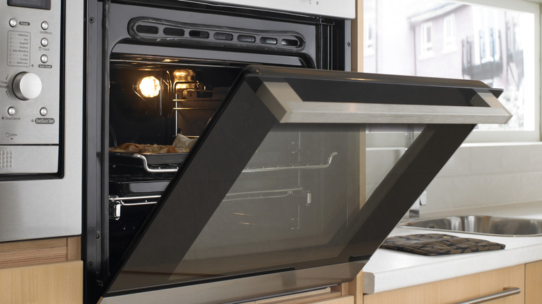 A slightly ajar oven door showing what's inside the oven