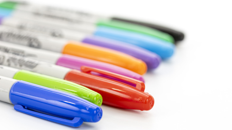 Assorted Sharpies on a white surface