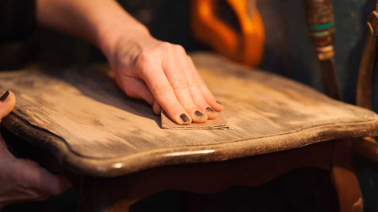 Woman sanding away an old finish