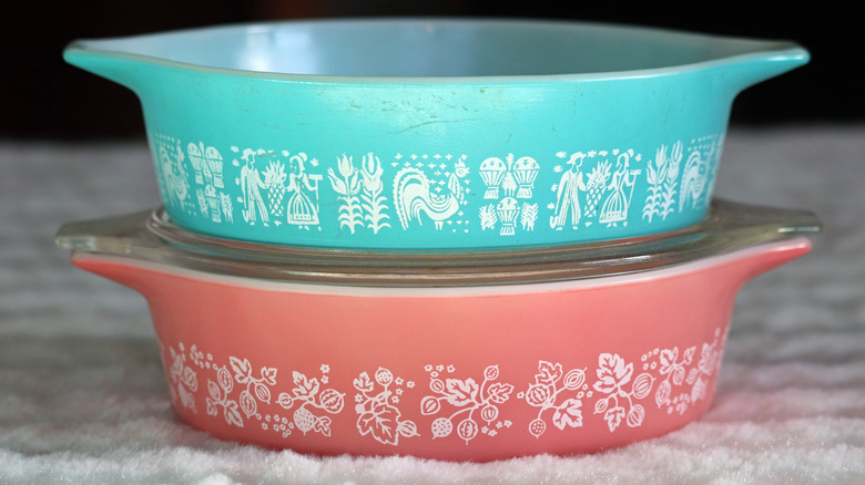 Stacked turquoise and pink Pyrex casserole dishes