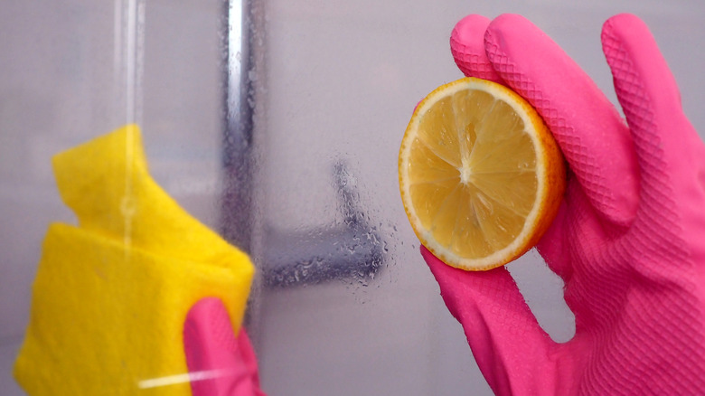 Cleaning a shower door with lemon