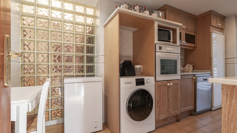 Pickled oak cabinets in a combination kitchen and laundry room