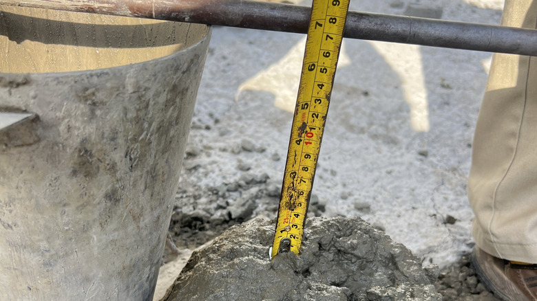 Person measuring the slump of concrete