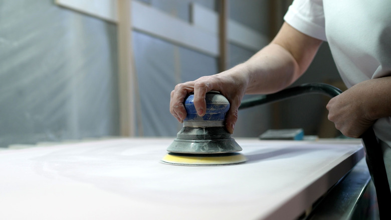 Hand sanding a panel