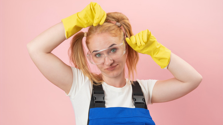 Woman wearing goggles and rubber gloves