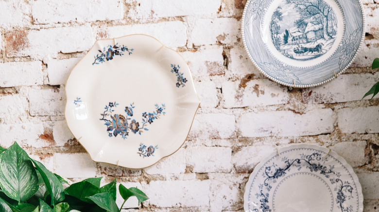 plates displayed on brick wall