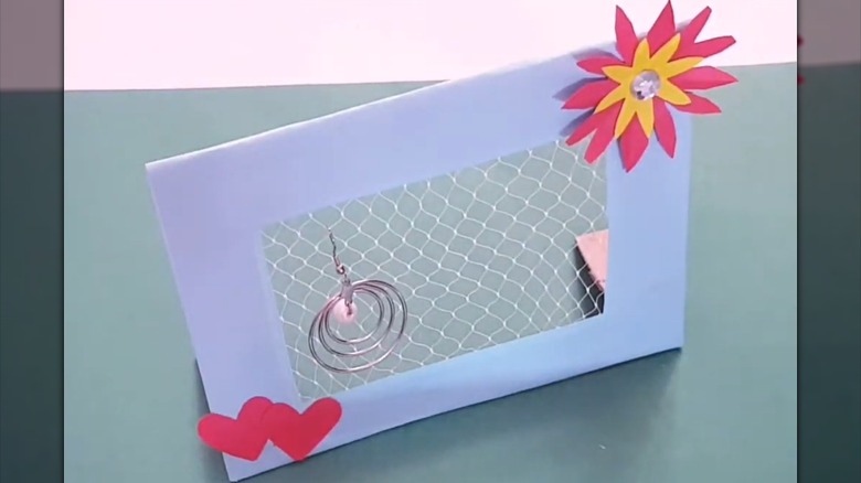 DIY lilac picture frame earring holder with flower embellishments and white veggie netting