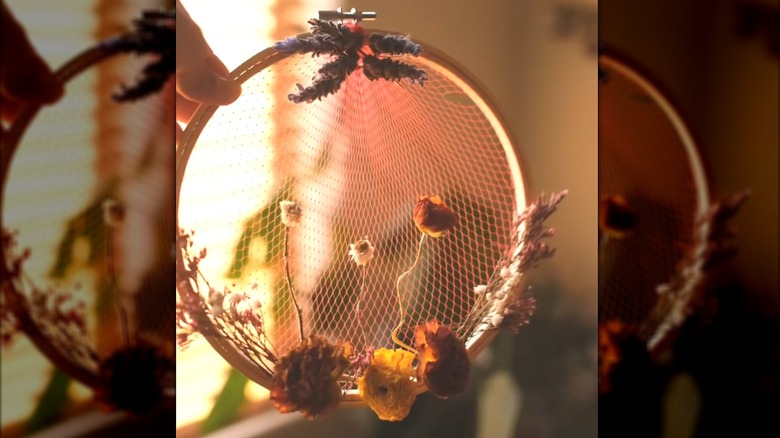 Unique mesh wall hanger made of round embroidery frame and plastic produce bags