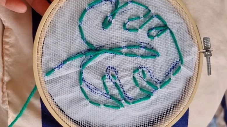 Produce bag used as template in embroidery project on embroidery hoop