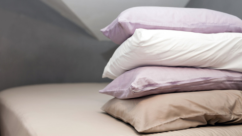 stack of pillows on bed