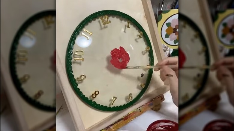 A glass clock transformed from a glass pot lid, paint, and spare clock mechanism.
