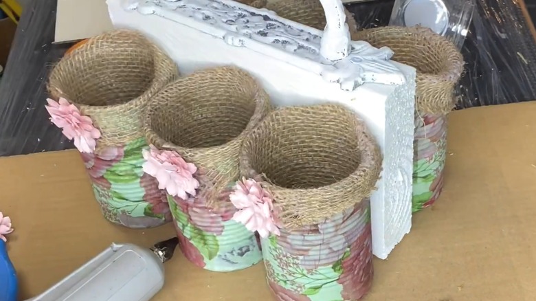 Shabby chic rustic soup cans attached to centerpiece with handle