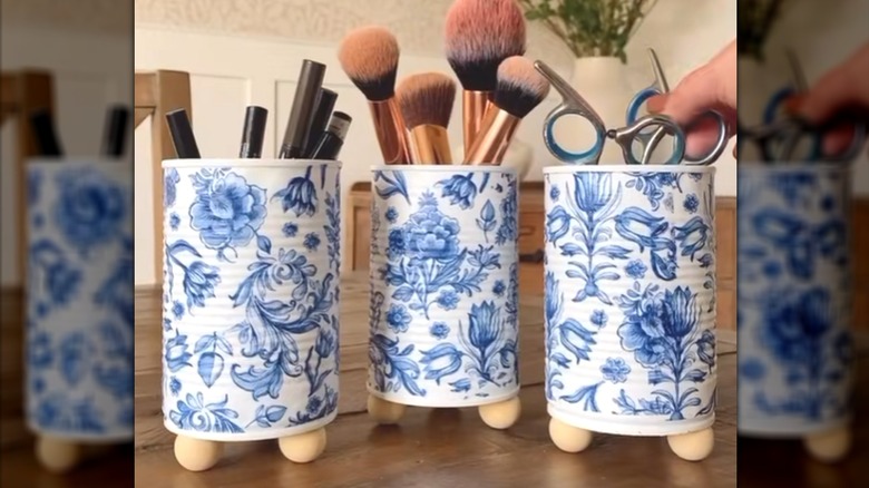 Blue chinoiserie tin can organizers on wood knobs with desk and vanity items