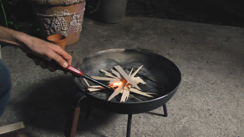 A DIY fire pit made from an old frying pan