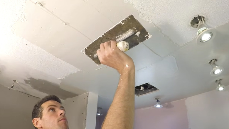 Skim coating to smooth over a textured popcorn ceiling