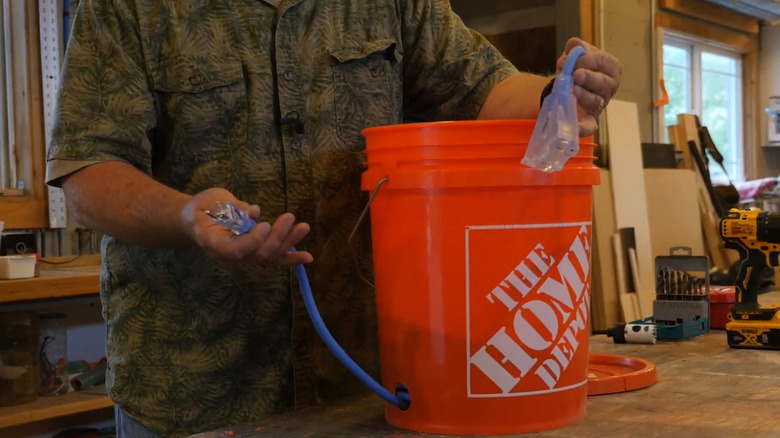 Showing off the business ends of an extension cord bucket