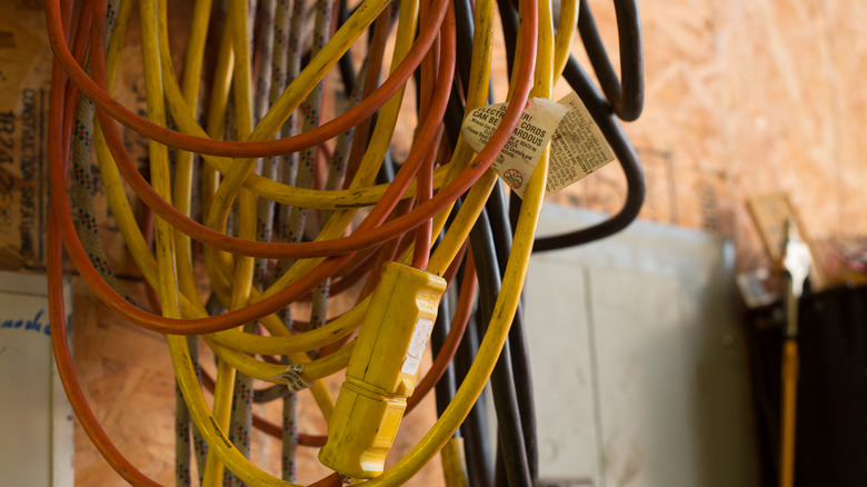 Tangled extension cords in a workshop