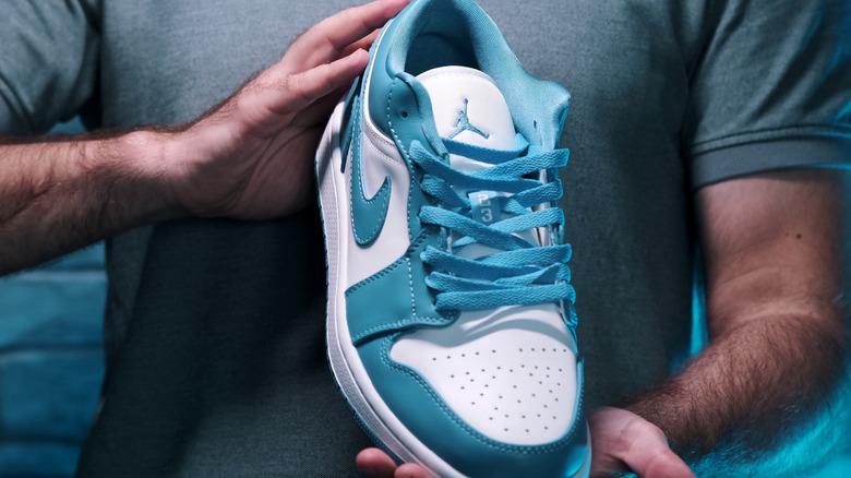 Man holding shoes