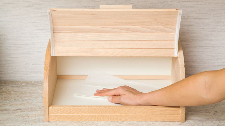 Person cleaning breadbox