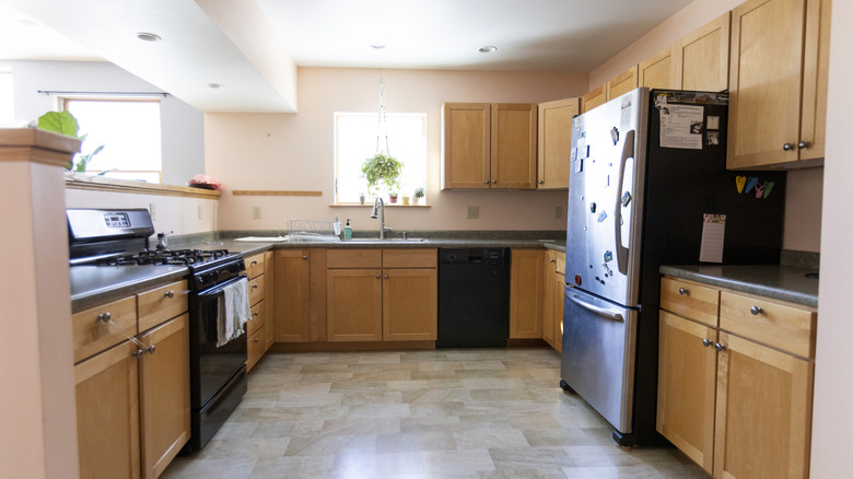 dated kitchen with black countertops