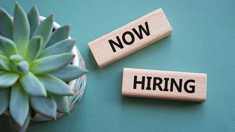 "Now Hiring" spelt out with wooden blocks