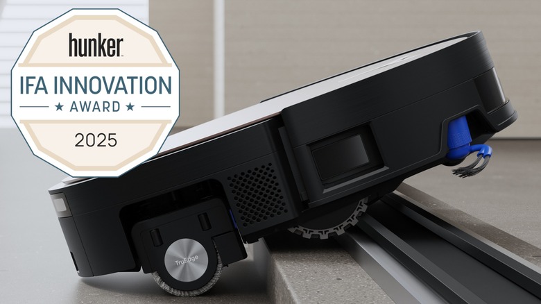 DEEBOT X11 OMNICYCLONE robot vacuum climbing up a high stepped flooring transition