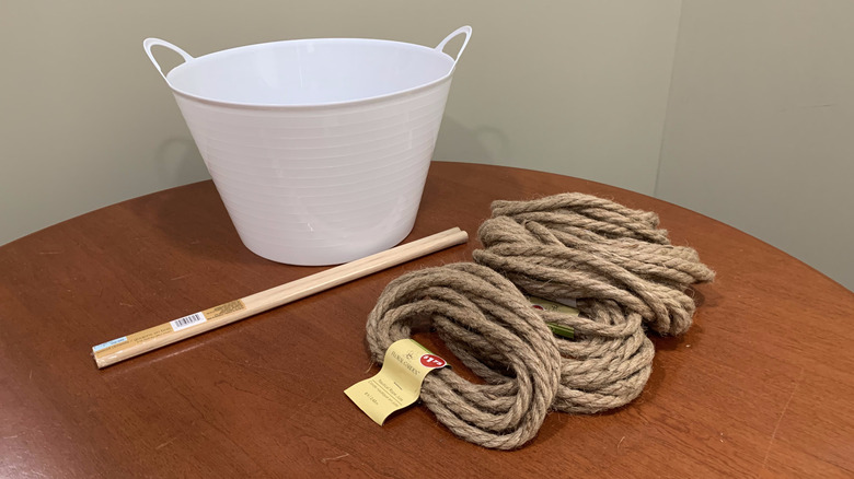 Dollar Tree bucket, dowels, and rope