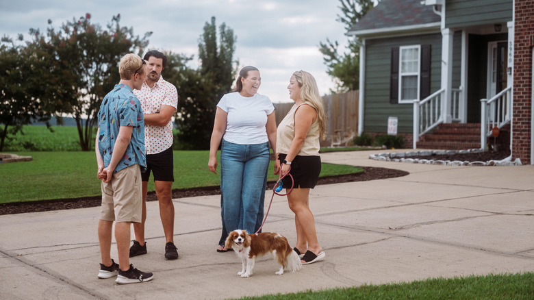 People standing in the driveway talking