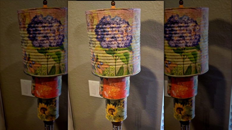 DIY wind chimes made from tin cans and paper napkins.