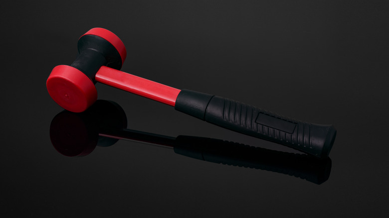 A dead blow hammer on a reflective surface