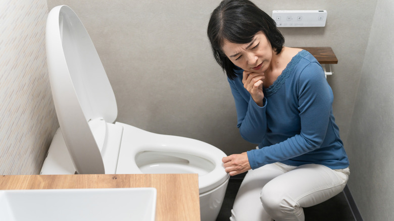 Alarmed man holding toilet tissue
