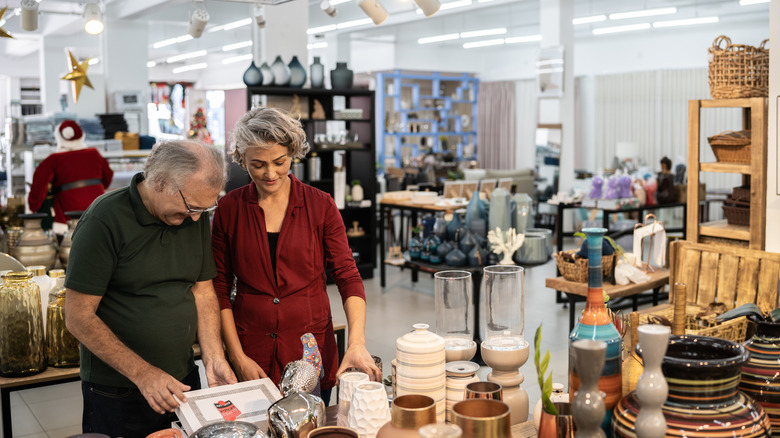 Older couple looking at vintage dishware