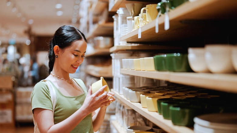 a woman shops for kitchen containers at a store