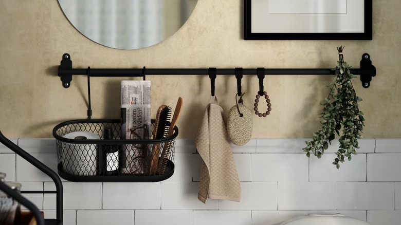 IKEA HULTARP Rail with bathroom accessories hanging from hooks