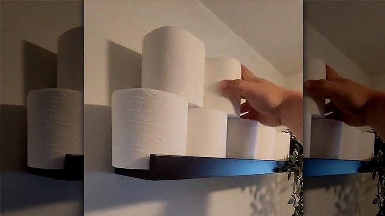 IKEA MOSSLANDA Picture ledge with toilet paper stacked on top